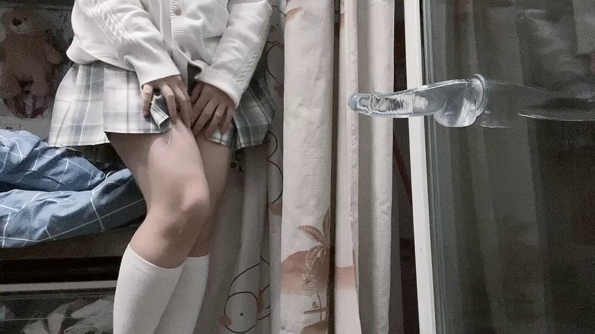 Young Woman in Sailor Uniform Fucks Her Wet Pussy with a Dildo by the Window, Squirting