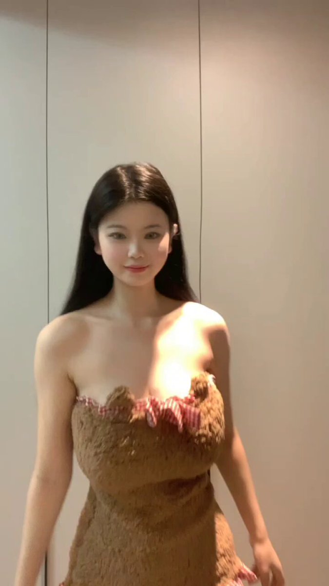 Long-haired beauty in a plush, breast-revealing bear outfit teases with seductive poses — big breasts bouncing irresistibly!