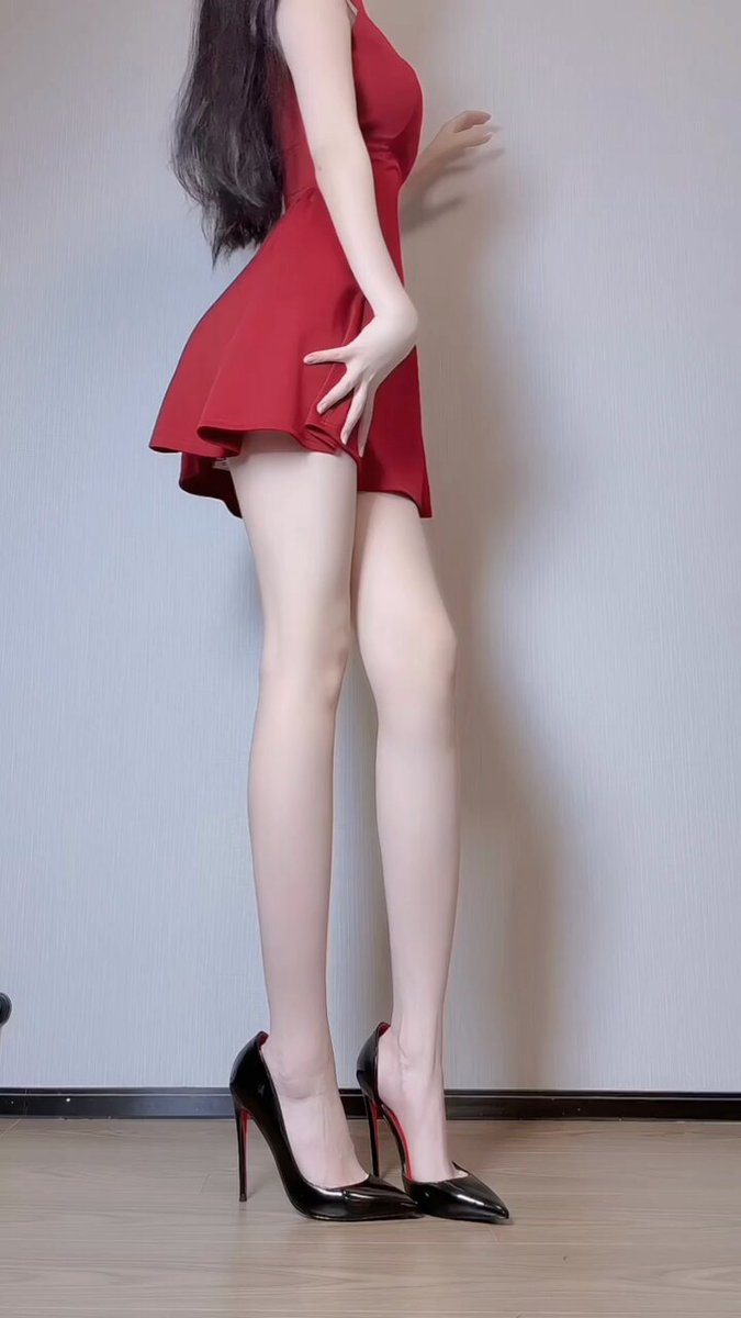 Red Dress Beauty with a Perky Butt in a Squatting Pose — High Heels & Stockings Keep Her Legs Moving!