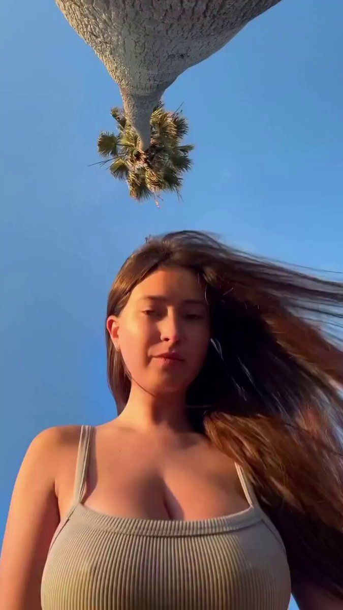 Busty Beauty Swaying Under Palm Trees — Deep-V Cleavage Temptation Showcase