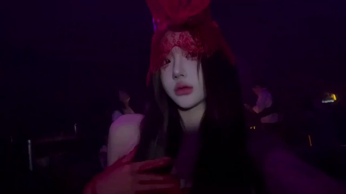 Red Veil Seductress Licking Her Lips in a Club — Off-Shoulder Busty Beauty with a Hungry, Mesmerizing Gaze