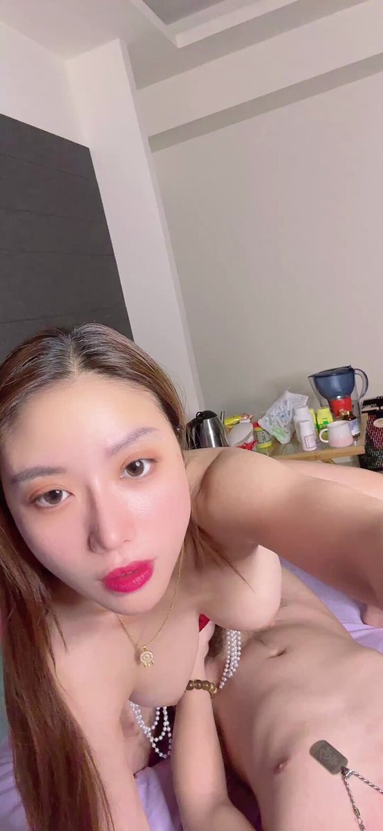 Long-haired beauty straddles a man's shaft and furiously strokes his cock; beaded chain-wrapped lewd selfie