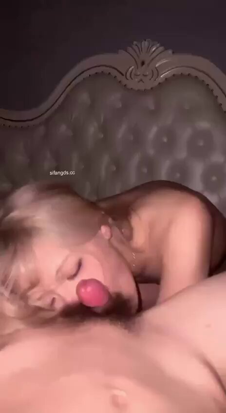 Blonde beauty wildly licks huge balls on the bed — pink lips envelop the testicles in deep‑throat swallowing