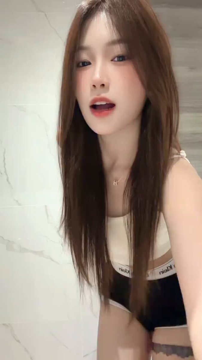 Bathroom babe with long legs and perky butt dances seductively — ultra-short hotpants revealing tattoo