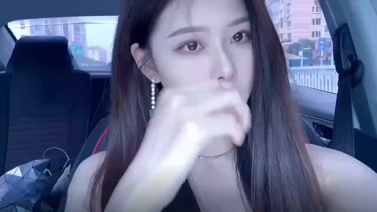 Car Temptation! Long-Haired Beauty Teases with Fingers on Her Lips