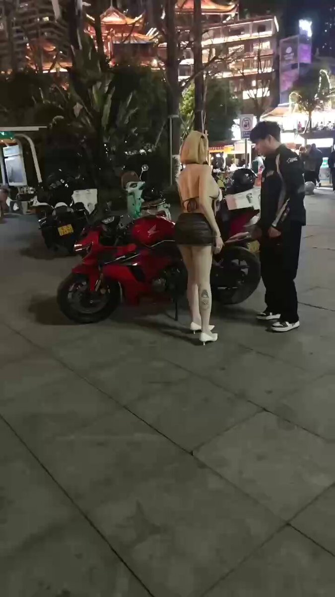 Street Tattooed Hot Girl Wardrobe Malfunction in a Micro Skirt! Shaking Her Perky Butt by a Motorcycle, Revealing Panties to Tempt Passersby