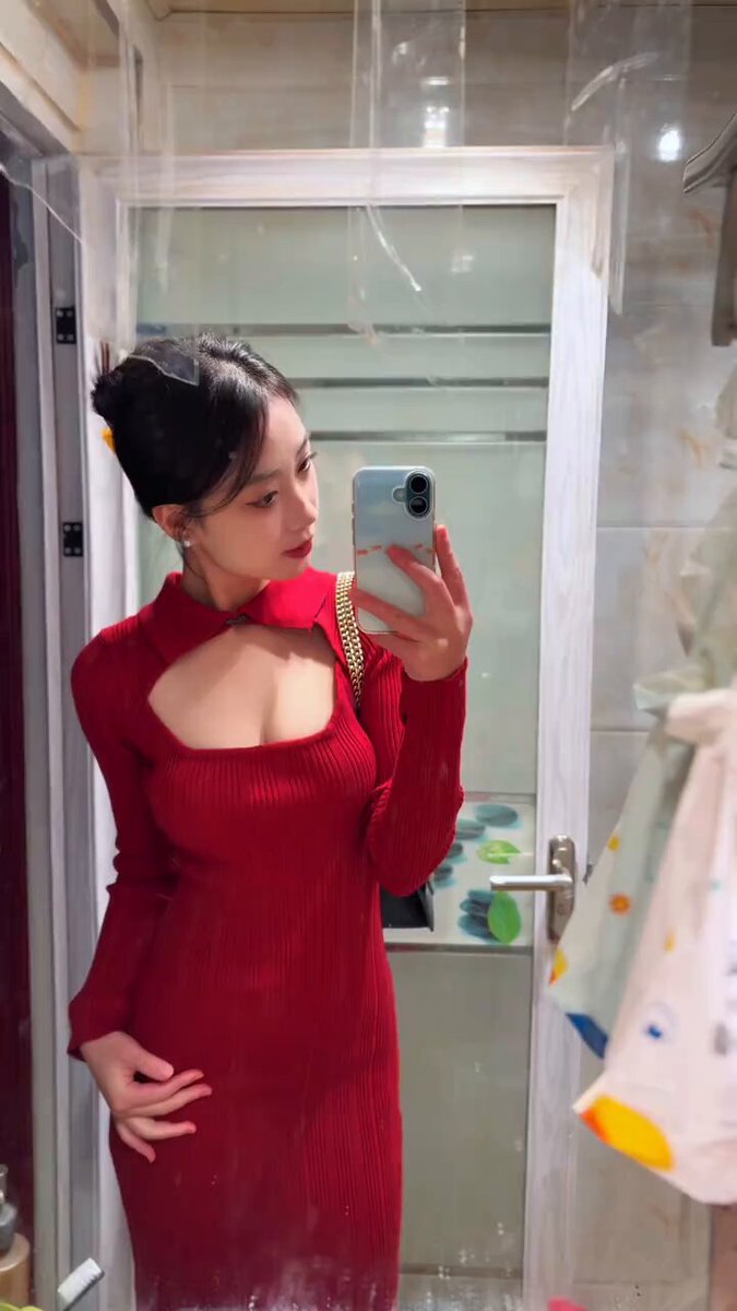 Red-dress beauty selfies in front of the bathroom mirror — deep V revealing cleavage and a perky butt, irresistible temptation!