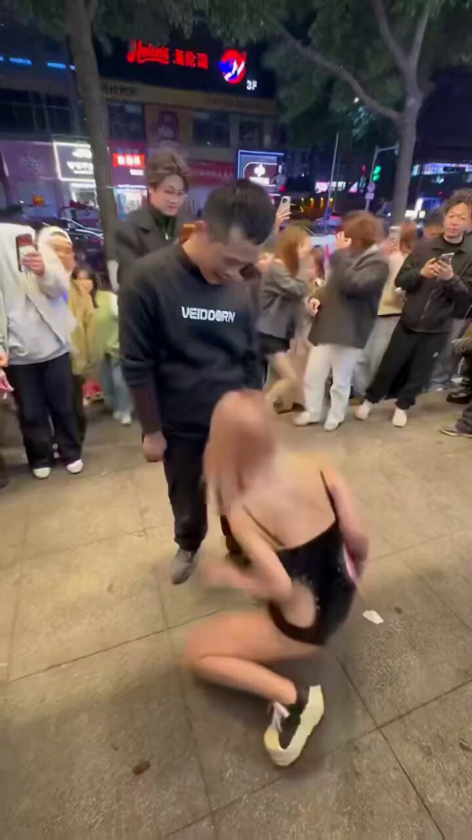Street Spectacle! Sexy Girl Kneels as Men Frenetically Grab Her Large Breasts and Rub Her Perky Butt
