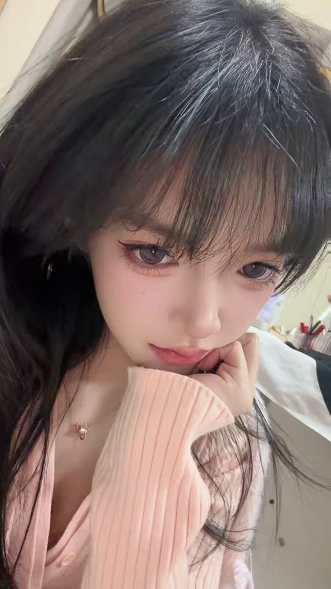 Black long-straight-haired beauty in a pink cardigan, low-cut temptation — seductive selfie gaze wants to be fucked