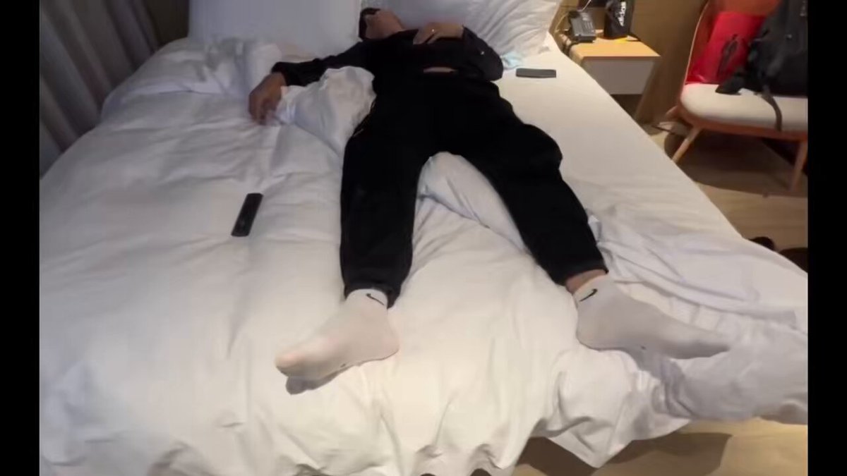 Handsome guy in white socks furiously strokes his big cock on a hotel bed — masturbating show, explosive ejaculation