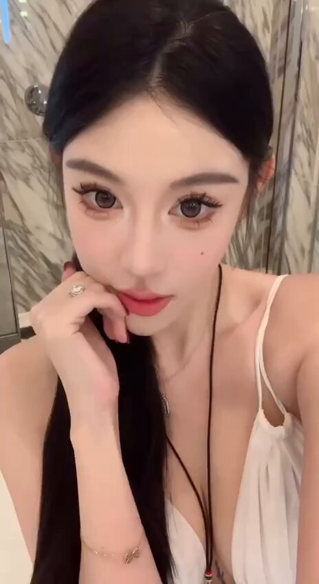 Seductive fox-like beauty in the bathroom in a deep-V camisole — self-touch teasing, big breasts bouncing