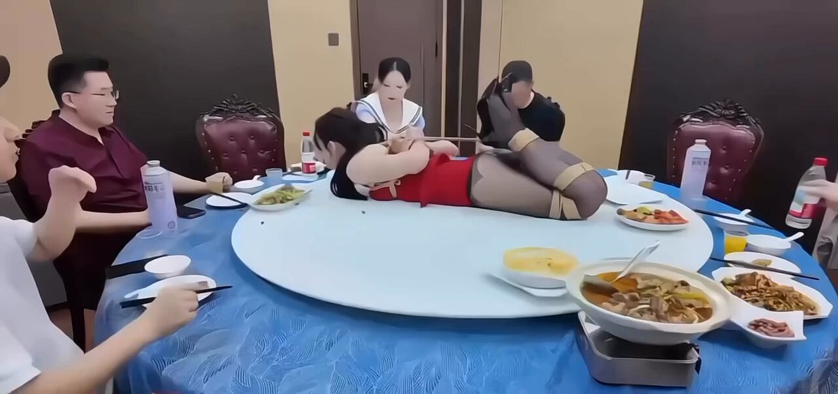 Beautiful woman tied by the legs in the center of the table! Red dress and black stockings, perky ass toyed with, tongue out begging to be fucked