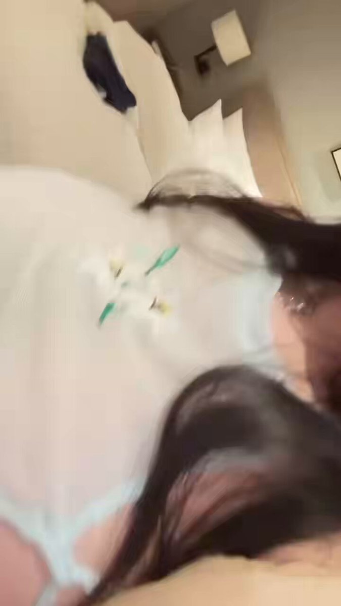 Long-legged beauty on hotel bed removes panties, revealing huge breasts and curvy hips