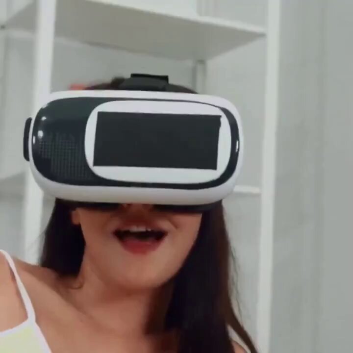 VR Virtual Reality Sex! Sexy Woman in a Headset on the Bed, Hips Raised and Writhing, Screaming in Ecstasy