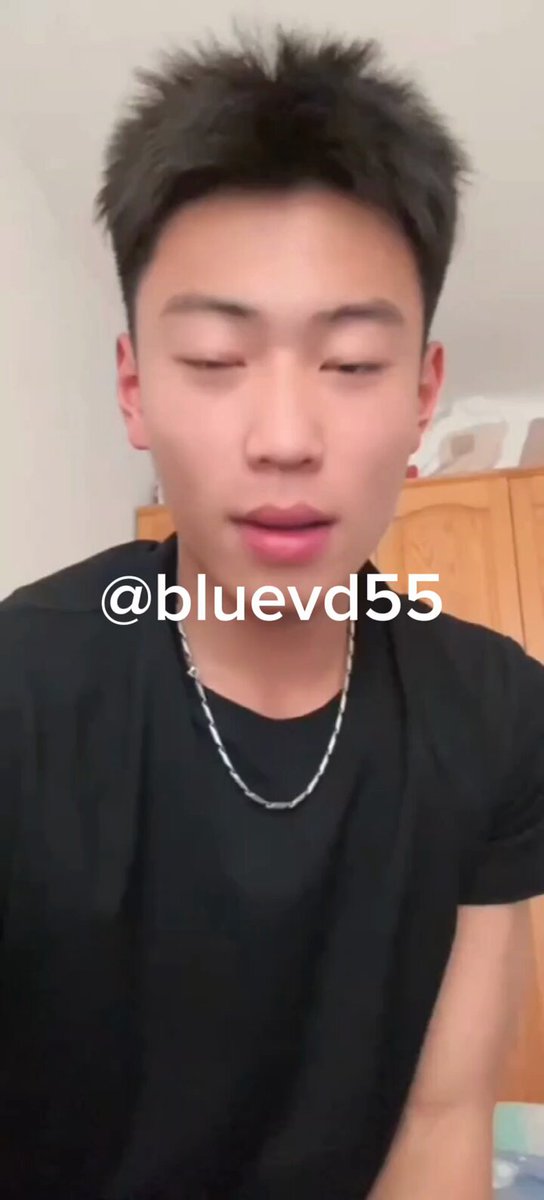 Handsome Asian young man self-stimulating on bed