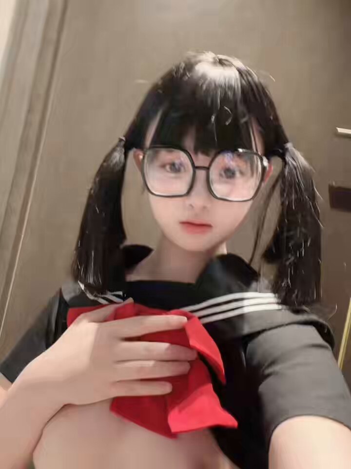Bespectacled black-haired twin-tail schoolgirl undresses, exposes huge breasts and self-pleasures