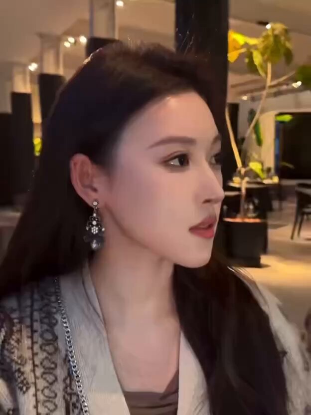 Long-Haired Beauty Seduces in Hotel — Low-Cut Long Dress, Captivating Side Profile