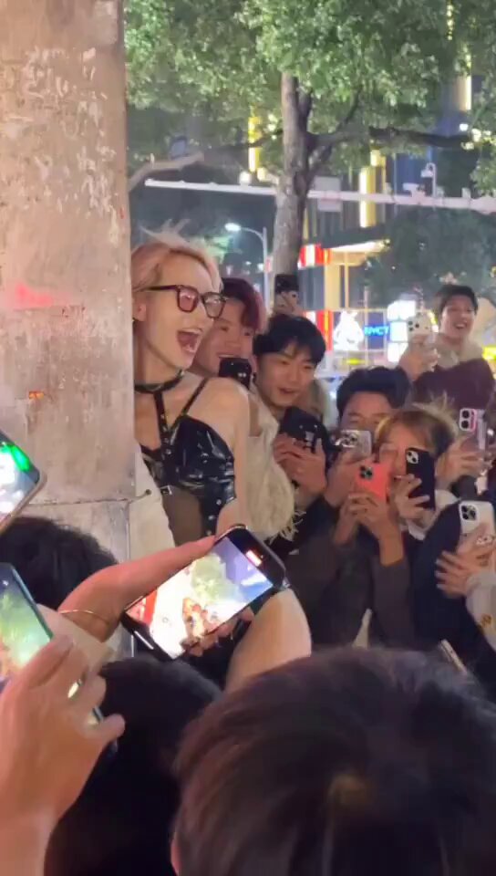 Street Blonde in Ultra-Revealing Black Latex Dances! Onlookers Snap Photos of Her Big Breasts and Perky Butt