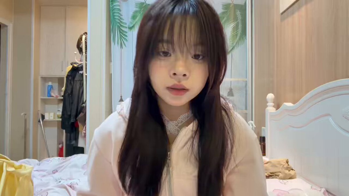 Cute Bangs Girl in Pink Hoodie on Bed, Legs Up Showing Off Her Beautiful Feet