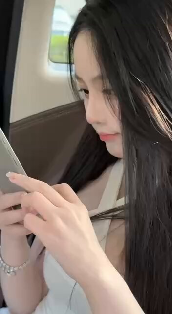 Long black-straight-haired beauty in the car teases with her fingers, deep-V cleavage about to show!