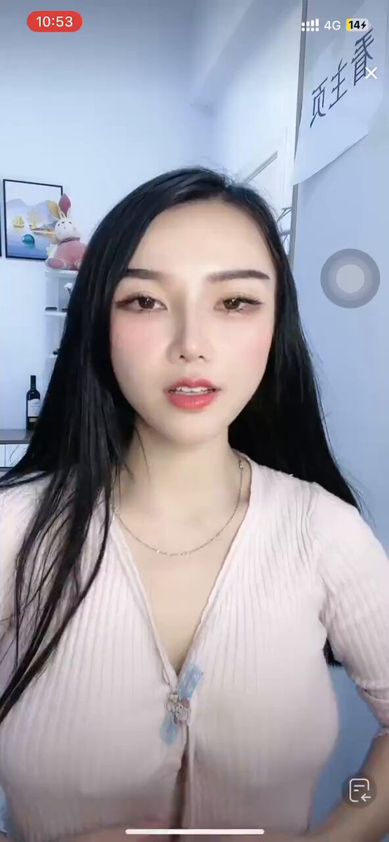 Long black straight-haired beauty livestreams in a deep V, breasts on display, fingers teasing her cherry-like mouth — irresistibly seductive!