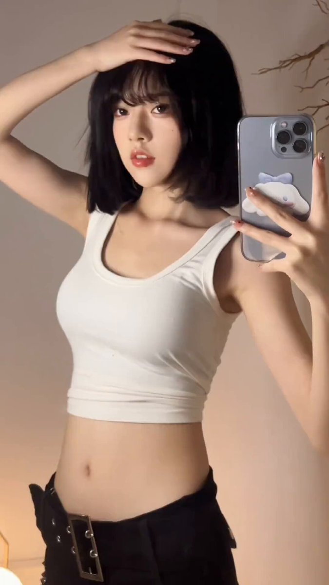 Blunt‑bang beauty selfies showing defined abs! White T exposes navel, tight hotpants tempt with busty cleavage