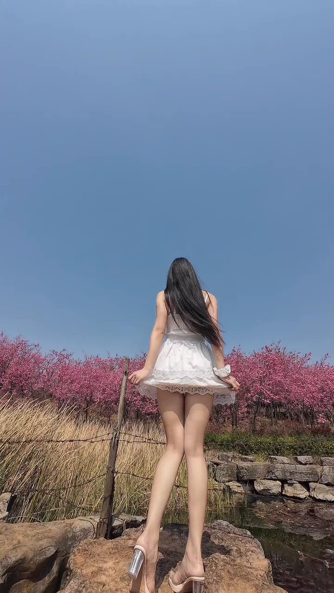 White Dress Beauty Tempts with Perky Butt in a Sea of Flowers — High Heels & Long Legs Show Off Sexy Vibe | 123av.fun Exclusive